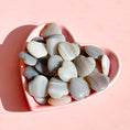 Load image into Gallery viewer, Group of grey and white agate hearts lay in a pink heart bowl on a soft pink background. 
